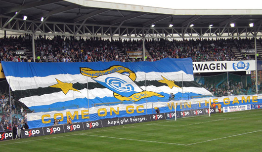 Seit 1929 Heimat des GCZ und seiner Fans.<br />Bild: www.gc-zone.ch“><figcaption>Seit 1929 Heimat des GCZ und seiner Fans.<br />Bild: www.gc-zone.ch</figcaption></figure>
<figure><img decoding=