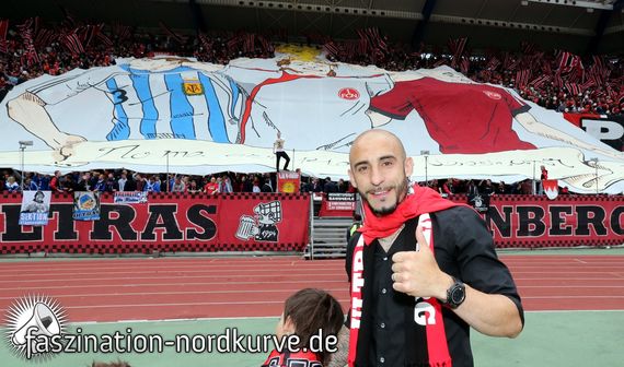 Javier Pinola mit einem Schal der Ultras Nürnberg<br />    <button type=