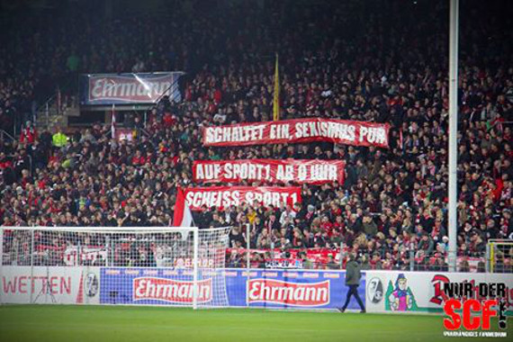 Das Spruchband gegen Sport1 beim Spiel gegen den KSC<br />    <button type=